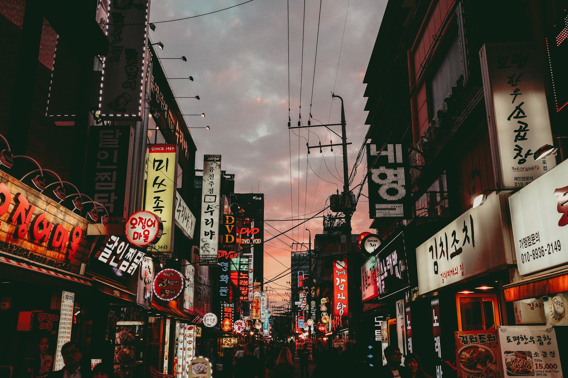 A urban scene in Seoul South Korea at dusk featuring neon light